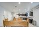 Bright kitchen with stainless steel appliances, granite countertops, and adjacent wooden dining table, perfect for gatherings at 5267 E Diatomite Dr, San Tan Valley, AZ 85143