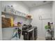 Clean laundry room with washer, dryer, storage shelves and hanging rack at 5267 E Diatomite Dr, San Tan Valley, AZ 85143