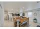 Open-concept living room with dining area boasts tiled floors, white walls, and a charming wood dining set at 5267 E Diatomite Dr, San Tan Valley, AZ 85143