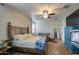 Cozy main bedroom with a decorative metal frame bed, ceiling fan, and natural light at 5267 E Diatomite Dr, San Tan Valley, AZ 85143