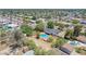 Residential area aerial showcasing a beautiful backyard pool, mature trees, and well-maintained landscaping at 6330 E Delcoa Ave, Scottsdale, AZ 85254