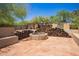 Desert backyard with an outdoor fireplace at 6330 E Delcoa Ave, Scottsdale, AZ 85254