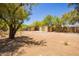 Expansive backyard featuring two storage sheds and desert landscaping at 6330 E Delcoa Ave, Scottsdale, AZ 85254