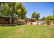 Beautiful backyard features a large pool, lush greenery, and outdoor seating, perfect for relaxing and entertaining at 6330 E Delcoa Ave, Scottsdale, AZ 85254