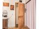 Bright bathroom with a wooden door, decorative art, and a marble countertop vanity, offering a unique rustic charm at 6330 E Delcoa Ave, Scottsdale, AZ 85254