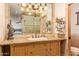 Tiled bathroom featuring a granite vanity, glass shower, and decor accents at 6330 E Delcoa Ave, Scottsdale, AZ 85254