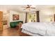 Cozy bedroom featuring exposed ceiling fan, a glass door to the exterior, and a private bath at 6330 E Delcoa Ave, Scottsdale, AZ 85254