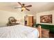 Bright bedroom featuring exposed ceiling fan, a connected bath, and decor accents at 6330 E Delcoa Ave, Scottsdale, AZ 85254
