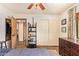 Spacious bedroom with a large window, ceiling fan, and a closet with sliding doors, perfect for relaxation and storage at 6330 E Delcoa Ave, Scottsdale, AZ 85254