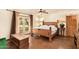 Bright bedroom featuring exposed ceiling fan, a glass door to the exterior, and rustic accents at 6330 E Delcoa Ave, Scottsdale, AZ 85254