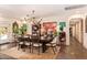Elegant dining room with a large table, stylish chandelier, and abundant natural light from a glass door at 6330 E Delcoa Ave, Scottsdale, AZ 85254