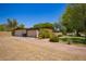 Exterior of a single-story home with a wide driveway and desert landscaping, offering privacy at 6330 E Delcoa Ave, Scottsdale, AZ 85254