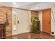 Foyer featuring unique stone accent walls, a decorative cabinet, and wood accents at 6330 E Delcoa Ave, Scottsdale, AZ 85254