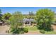 Charming single-story home featuring a well-manicured lawn and mature trees at 6330 E Delcoa Ave, Scottsdale, AZ 85254