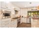 Gourmet kitchen equipped with stainless steel appliances, granite countertops, and custom white cabinetry at 6330 E Delcoa Ave, Scottsdale, AZ 85254
