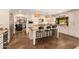 Modern kitchen with stainless steel appliances, a central island, and open access to an adjoining living space at 6330 E Delcoa Ave, Scottsdale, AZ 85254