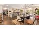 Open-concept kitchen and dining area featuring modern appliances, a central island, and backyard access at 6330 E Delcoa Ave, Scottsdale, AZ 85254