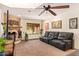 Inviting living room featuring a comfortable sofa, decorative fireplace, and view of the backyard pool at 6330 E Delcoa Ave, Scottsdale, AZ 85254