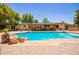 Backyard pool with rocks and brick patio at 6330 E Delcoa Ave, Scottsdale, AZ 85254