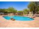 Backyard swimming pool surrounded by lush desert landscaping at 6330 E Delcoa Ave, Scottsdale, AZ 85254