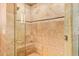 Close up of the shower with tiled walls, glass door, and tile flooring at 6330 E Delcoa Ave, Scottsdale, AZ 85254