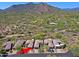 Breathtaking aerial view of desert home showcasing lush landscaping and mountain views at 6714 E Nightingale Cir, Scottsdale, AZ 85266