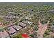 Desert aerial view of homes with sparkling pools, well-manicured yards, and natural surroundings at 6714 E Nightingale Cir, Scottsdale, AZ 85266