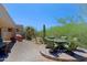 Landscaped back patio featuring a built-in table and seating area with desert landscaping at 6714 E Nightingale Cir, Scottsdale, AZ 85266