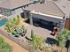 Aerial view of a private backyard featuring a covered patio, desert landscaping, and a fire pit at 6714 E Nightingale Cir, Scottsdale, AZ 85266