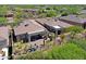 Aerial view of a private backyard featuring a covered patio, desert landscaping, and a fire pit at 6714 E Nightingale Cir, Scottsdale, AZ 85266