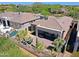 Aerial view of a private backyard featuring a covered patio, desert landscaping, and a fire pit at 6714 E Nightingale Cir, Scottsdale, AZ 85266