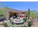 Exterior view of the back patio featuring desert landscaping and an outdoor table at 6714 E Nightingale Cir, Scottsdale, AZ 85266