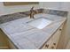 A close-up of a bathroom vanity with stone countertop and undermount sink at 6714 E Nightingale Cir, Scottsdale, AZ 85266