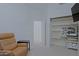 Comfortable bedroom with recliner and built in shelves and desk area at 6714 E Nightingale Cir, Scottsdale, AZ 85266