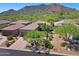 Desert home featuring xeriscaping, a multi-car driveway, and scenic mountain views at 6714 E Nightingale Cir, Scottsdale, AZ 85266