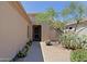 Front porch of a desert home featuring cacti, desert landscaping, and a security door at 6714 E Nightingale Cir, Scottsdale, AZ 85266