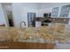 Updated kitchen featuring granite countertops, stainless steel appliances, and a breakfast bar area at 6714 E Nightingale Cir, Scottsdale, AZ 85266