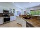 Spacious kitchen with stainless appliances, granite countertops, and backyard views at 6714 E Nightingale Cir, Scottsdale, AZ 85266