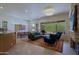 Bright living room with a stone fireplace, a large window, and desert views at 6714 E Nightingale Cir, Scottsdale, AZ 85266
