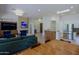 Spacious living room with an open layout, showcasing a stone fireplace, comfortable seating, and a modern kitchen at 6714 E Nightingale Cir, Scottsdale, AZ 85266