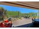 Covered patio featuring a decorative rock garden, desert landscaping, and unobstructed views at 6714 E Nightingale Cir, Scottsdale, AZ 85266