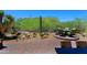 Paver patio boasts desert landscaping with cacti and a built-in seating area at 6714 E Nightingale Cir, Scottsdale, AZ 85266