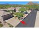 Desert home featuring xeriscaping, a multi-car driveway, and scenic mountain views at 6714 E Nightingale Cir, Scottsdale, AZ 85266