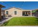 This backyard has green turf, a covered patio, and a string of lights perfect for entertaining at 7238 N 126Th Ln, Glendale, AZ 85307