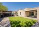 Inviting backyard features lush grass, outdoor seating and a covered patio at 7238 N 126Th Ln, Glendale, AZ 85307
