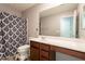 Well-lit bathroom with stylish vanity, large mirror, and shower-tub combination at 7238 N 126Th Ln, Glendale, AZ 85307