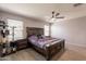 Spacious bedroom with wood-look flooring, ceiling fan, and natural light at 7238 N 126Th Ln, Glendale, AZ 85307