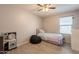 Cozy bedroom features neutral paint, wood-look tile and bright natural light at 7238 N 126Th Ln, Glendale, AZ 85307