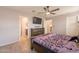 Large bedroom with wood-look floors and access to bathroom and closet at 7238 N 126Th Ln, Glendale, AZ 85307