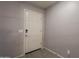 Neutral entryway featuring gray walls, tile flooring, and a classic white front door at 7238 N 126Th Ln, Glendale, AZ 85307